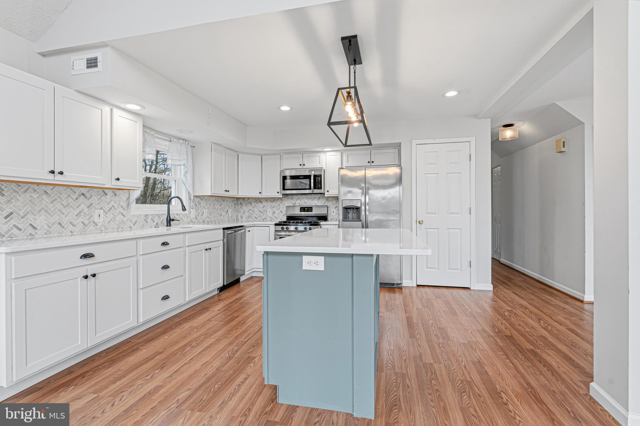 6812 Schaadts Road, Unit 6812 Middle River, MD 21220 - Photo 5 of 54 a kitchen with stainless steel appliances a sink cabinets and wooden floor