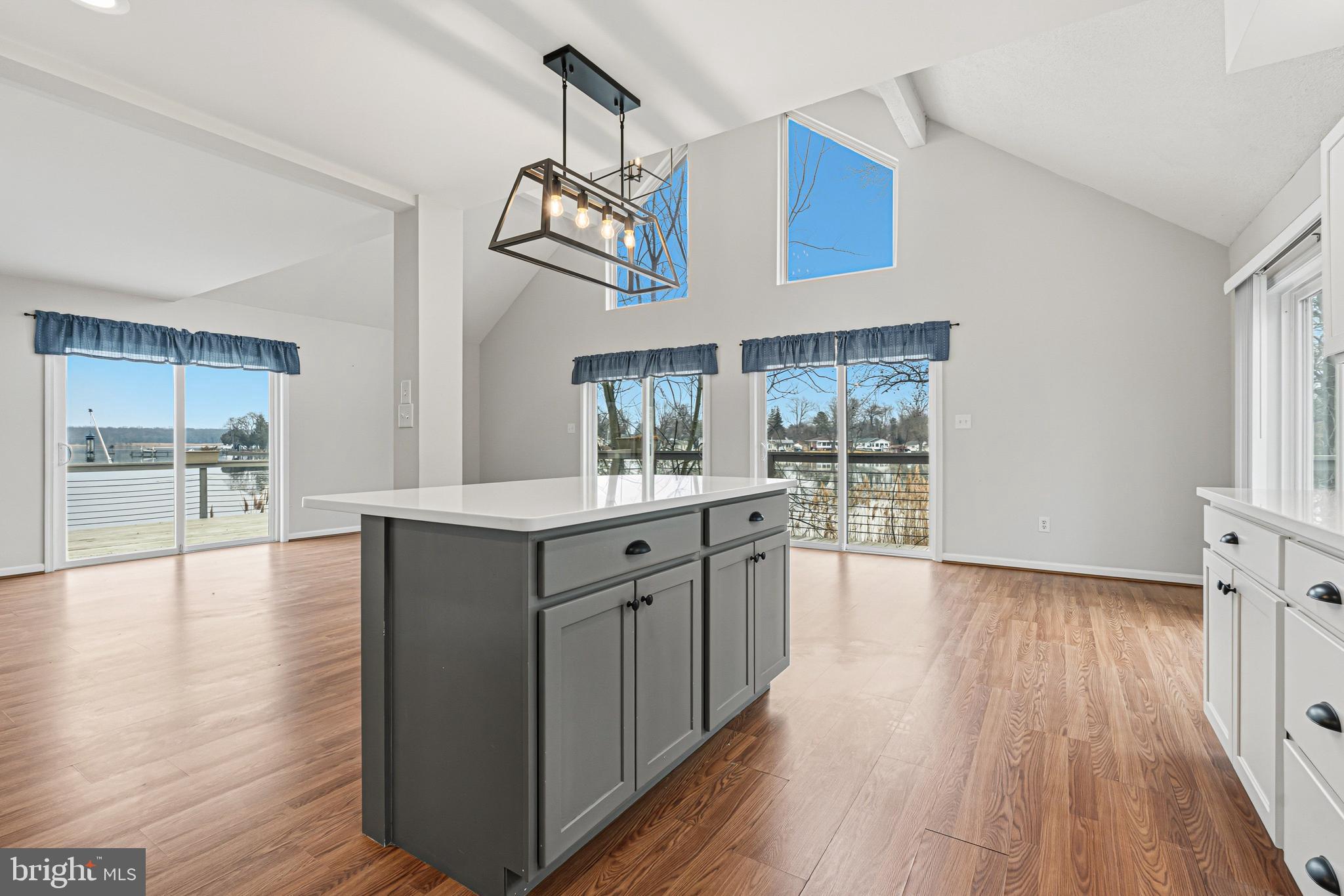 6812 Schaadts Road, Unit 6812 Middle River, MD 21220 - Photo 6 of 54 a large kitchen with stainless steel appliances a large counter top a sink and wooden floor