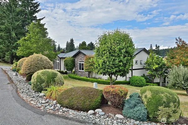 a front view of a house with garden