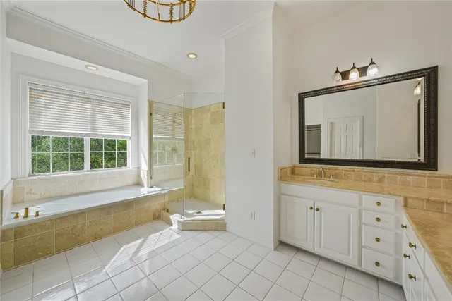 a bathroom with a bathtub a mirror a sink and a window