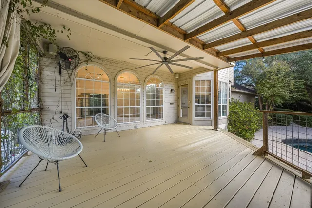 a view of a patio with table and chairs and wooden floor