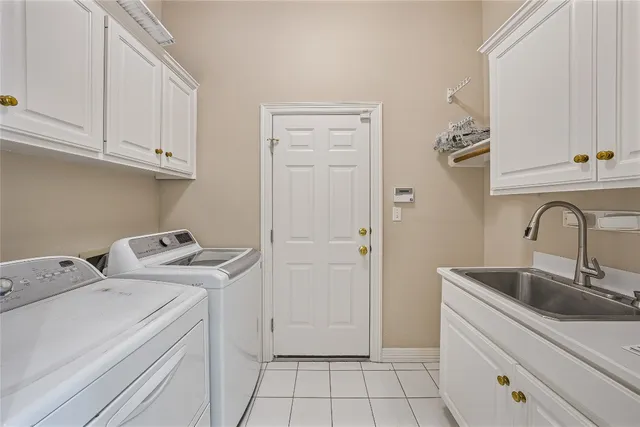 a view of storage and utility room with closet dryer
