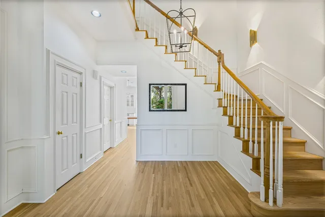 a view of entryway and hall with wooden floor