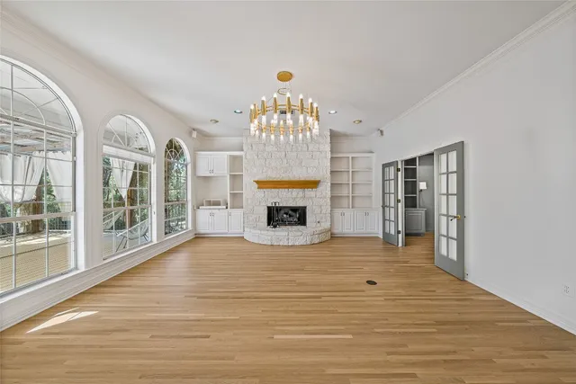 a view of an empty room with a fireplace and a window