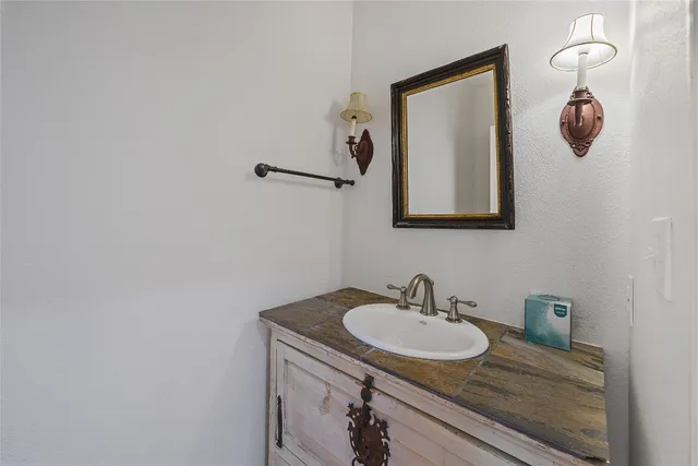 a bathroom with a sink and mirror
