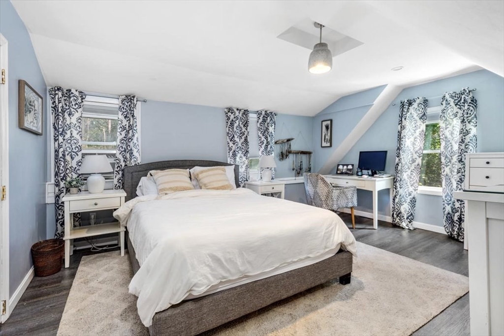 142 Tilden Road Scituate, MA 02066 - Photo 3 of 28 a large bed sitting in a bedroom and kitchen view