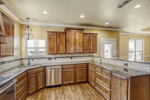 a kitchen with a sink stove and cabinets