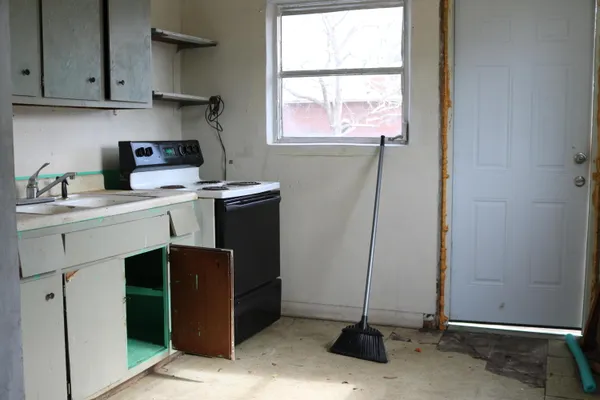 a room with a sink cabinets and window