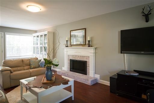 1766 Witt Way Drive Spring Hill, TN 37174 - Photo 6 of 13 a living room with furniture a flat screen tv and a fireplace