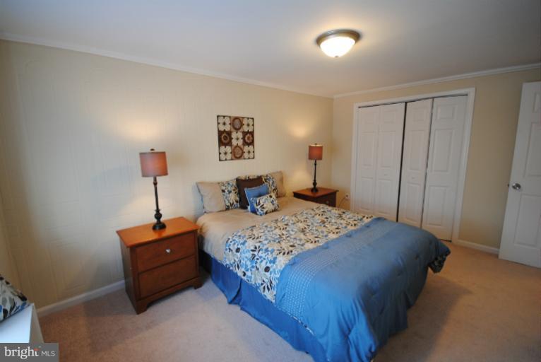 6206 Radecke Avenue Baltimore, MD 21206 - Photo 11 of 22 a bedroom with a bed and a painting on the wall