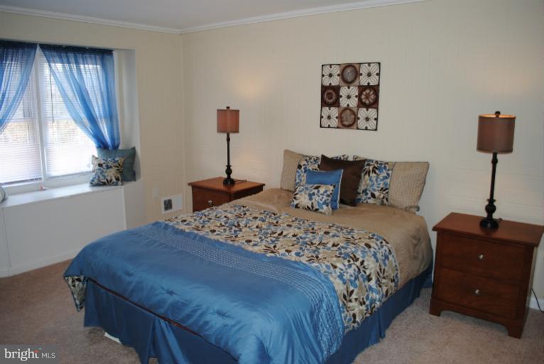 6206 Radecke Avenue Baltimore, MD 21206 - Photo 19 of 22 a bedroom with a bed and a window