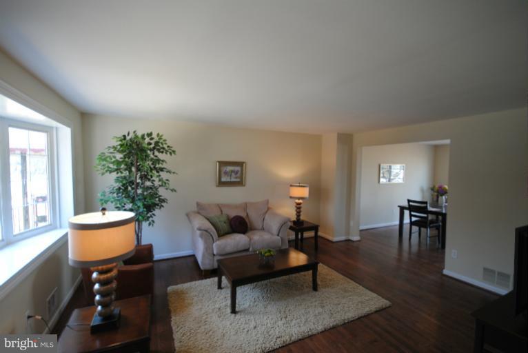 6206 Radecke Avenue Baltimore, MD 21206 - Photo 5 of 22 a living room with furniture a lamp a potted plant and a table