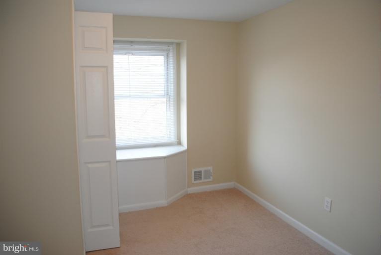 6206 Radecke Avenue Baltimore, MD 21206 - Photo 7 of 22 an empty room with a window