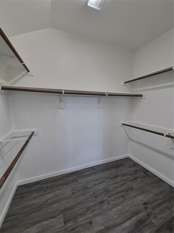 8050 Privet Street Forney, TX 75126 - Photo 14 of 24 Spacious closet featuring dark-toned flooring and white walls, complete with shelving and hanging rods for ample storage