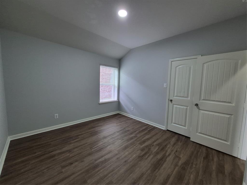 8050 Privet Street Forney, TX 75126 - Photo 15 of 24 This room features wood-look flooring, light grey walls, and a window with blinds