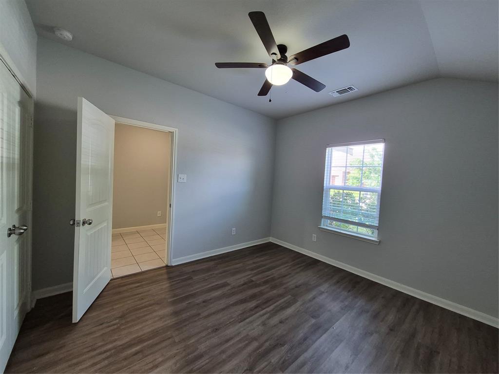 8050 Privet Street Forney, TX 75126 - Photo 16 of 24 This room features vaulted ceilings, a ceiling fan with integrated lighting, and dark wood-look flooring