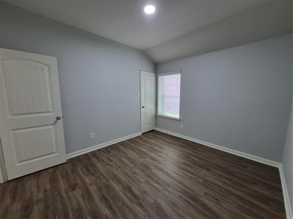 8050 Privet Street Forney, TX 75126 - Photo 17 of 24 This room features neutral-toned walls, wood-style flooring, a window with blinds, and white trim