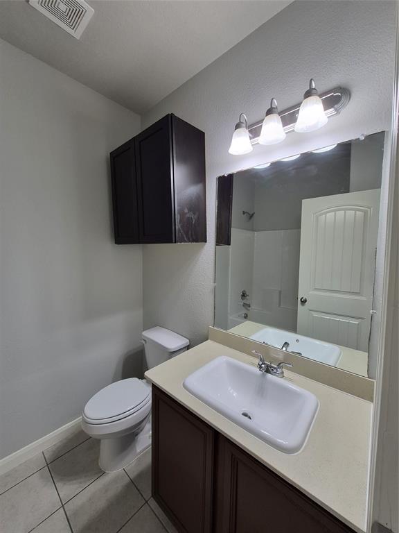8050 Privet Street Forney, TX 75126 - Photo 18 of 24 Bathroom featuring a vanity with a light-colored countertop, a sink with a chrome faucet, and a mirror with overhead lighting