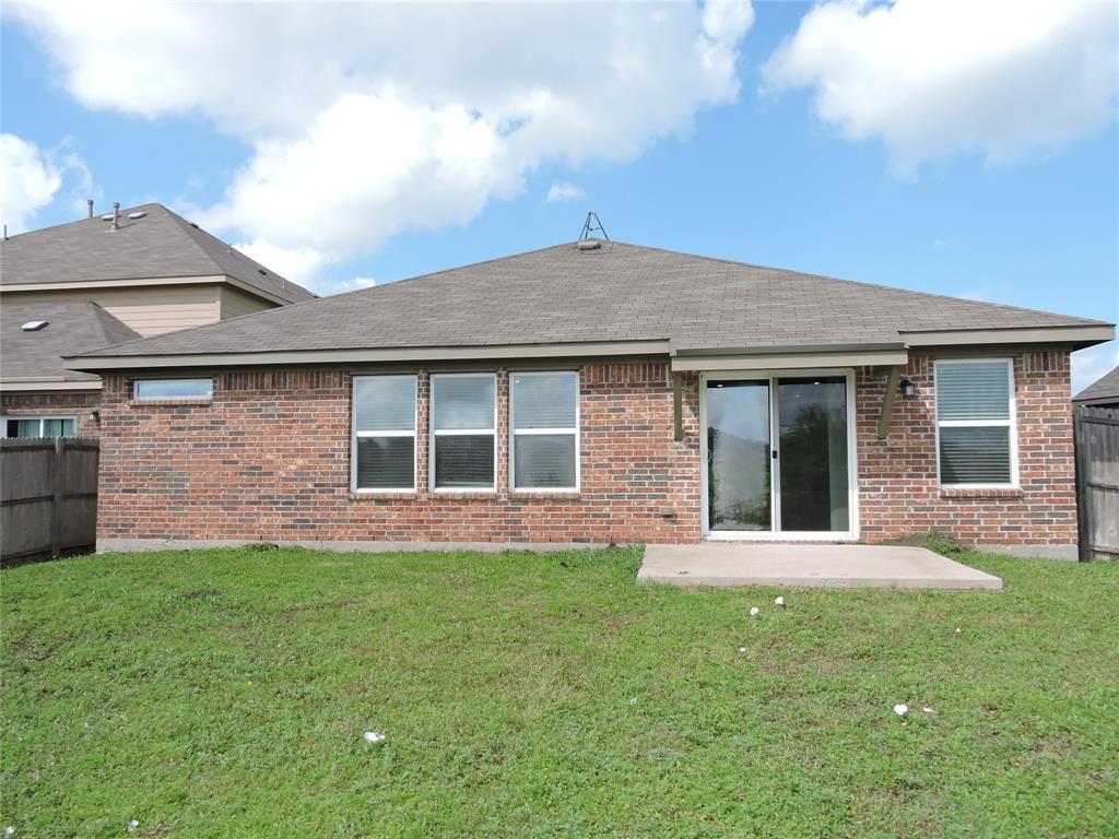 8050 Privet Street Forney, TX 75126 - Photo 21 of 24 The property features a brick exterior with a shingled roof