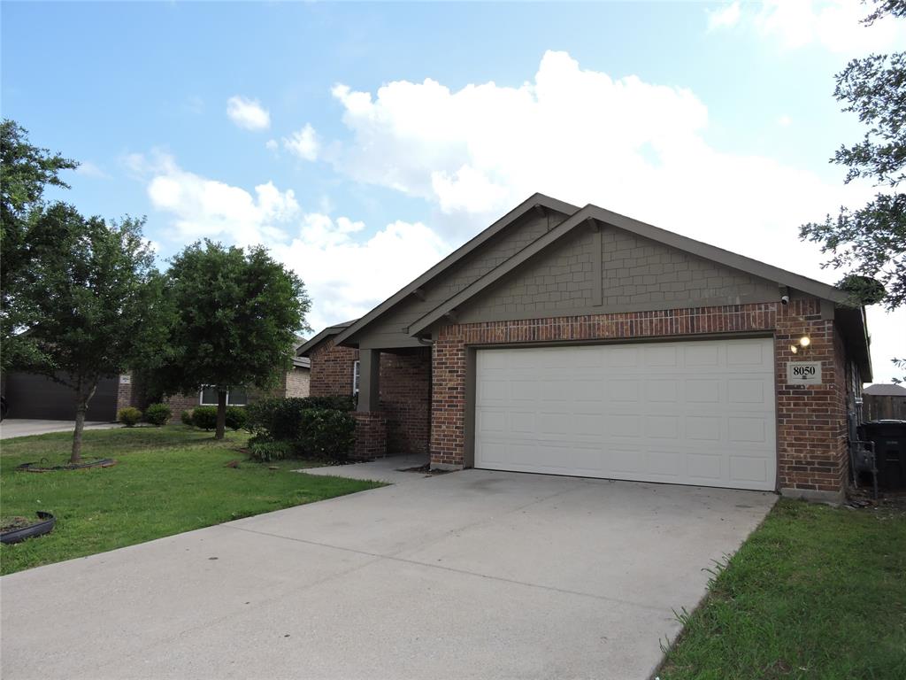 8050 Privet Street Forney, TX 75126 - Photo 24 of 24 The property features a brick exterior with a gabled roof and a two-car garage