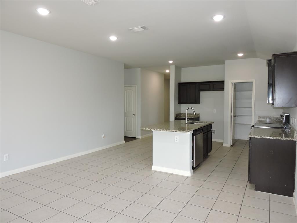 8050 Privet Street Forney, TX 75126 - Photo 4 of 24 The property features an open-concept living area with tile flooring and recessed lighting