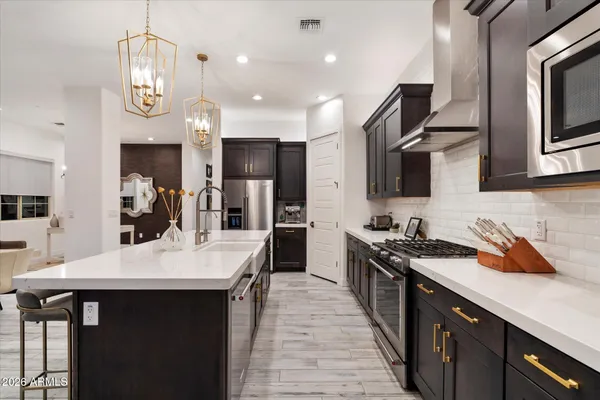 a view of a patio with couches table and chairs and potted plants