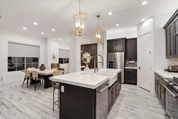 a view of a patio with couches table and chairs and potted plants