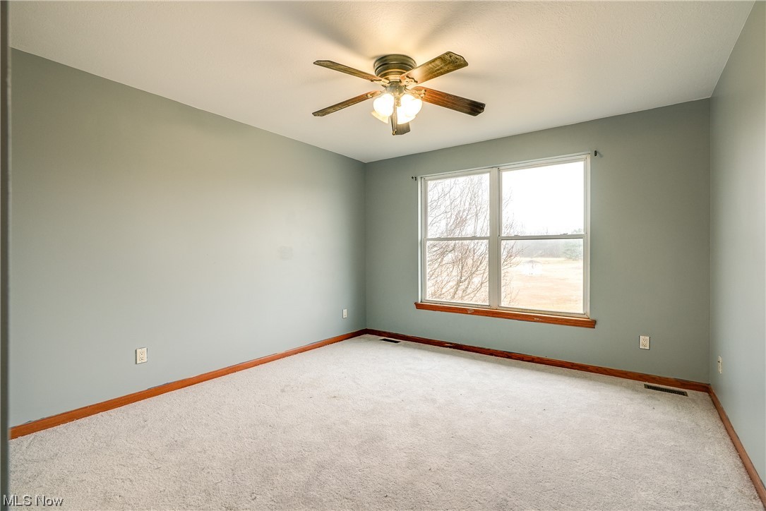 8837 Spieth Road Litchfield, OH 44253 - Photo 27 of 35 Large secondary bedroom with new carpet installed February 2023. There are a total of 4 bedrooms upstairs.