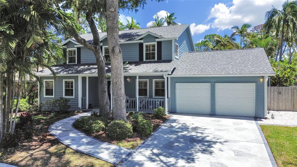 7645 Harborview Way Seminole, FL 33776 - Photo 1 of 55 a front view of a house with a yard and potted plants