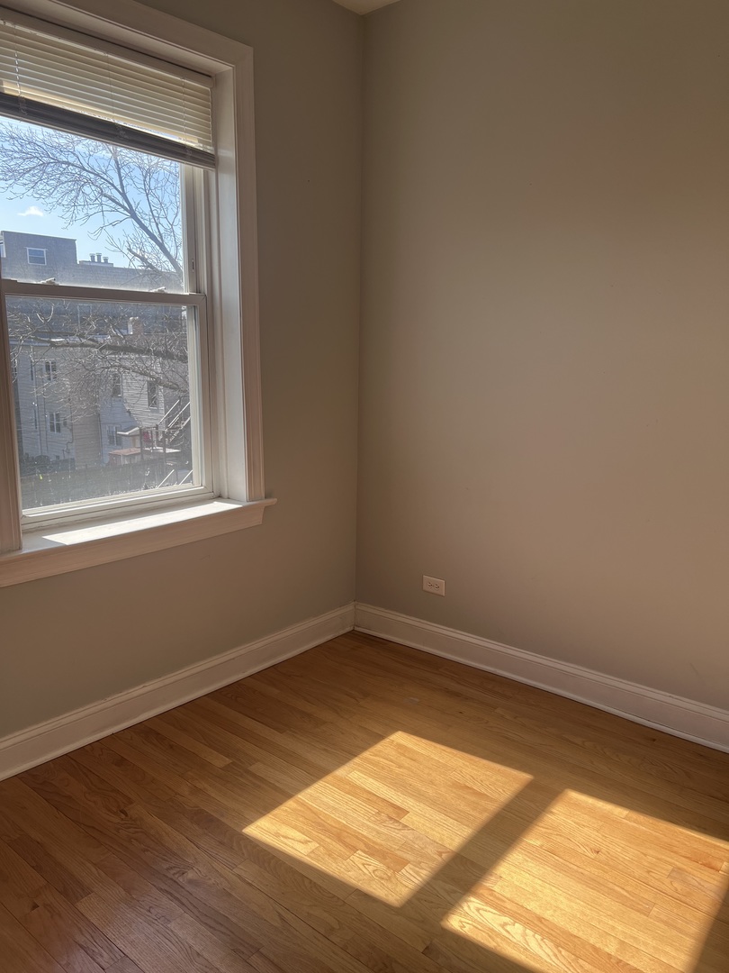 Undisclosed Address Chicago, IL 60622 - Photo 13 of 16 a view of empty room with wooden floor and fan