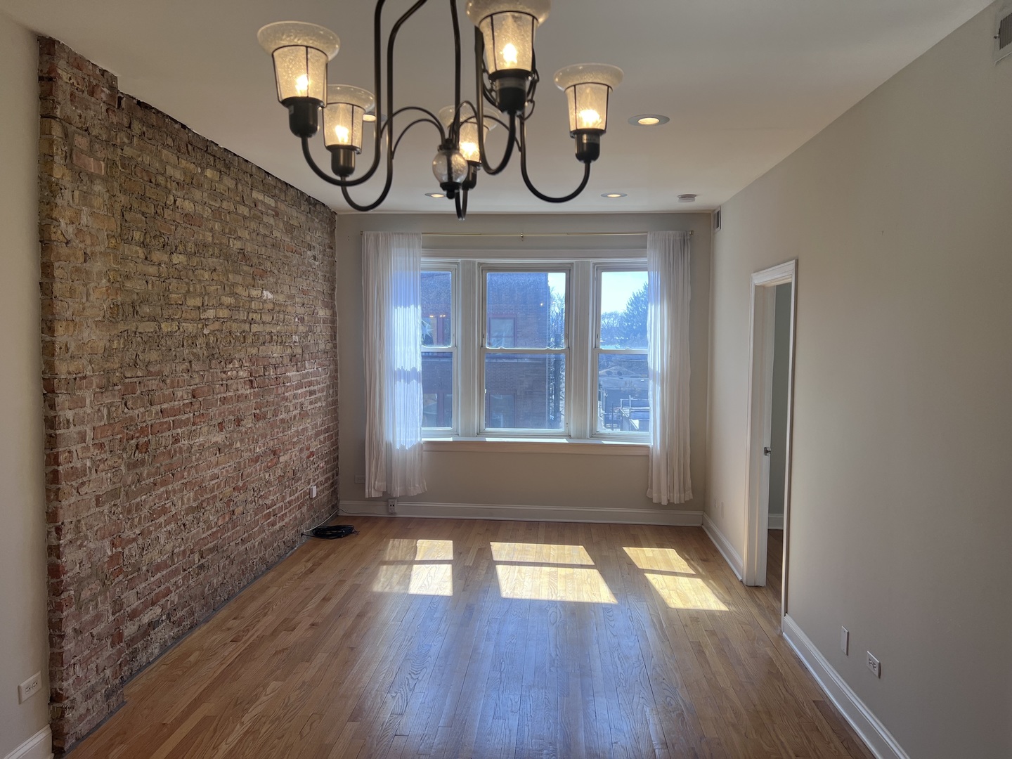 Undisclosed Address Chicago, IL 60622 - Photo 3 of 16 a view of empty room with wooden floor and fan
