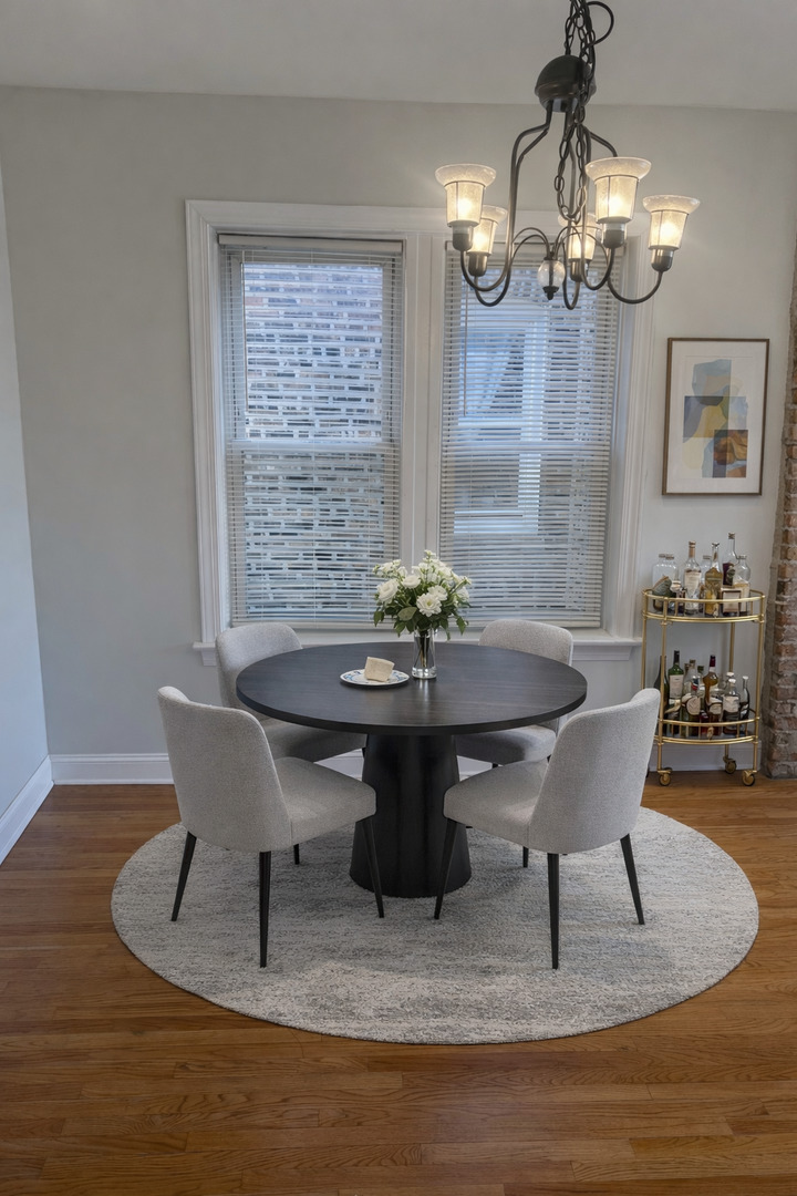 Undisclosed Address Chicago, IL 60622 - Photo 4 of 16 a dining room with wooden floor a chandelier a wooden table and chairs