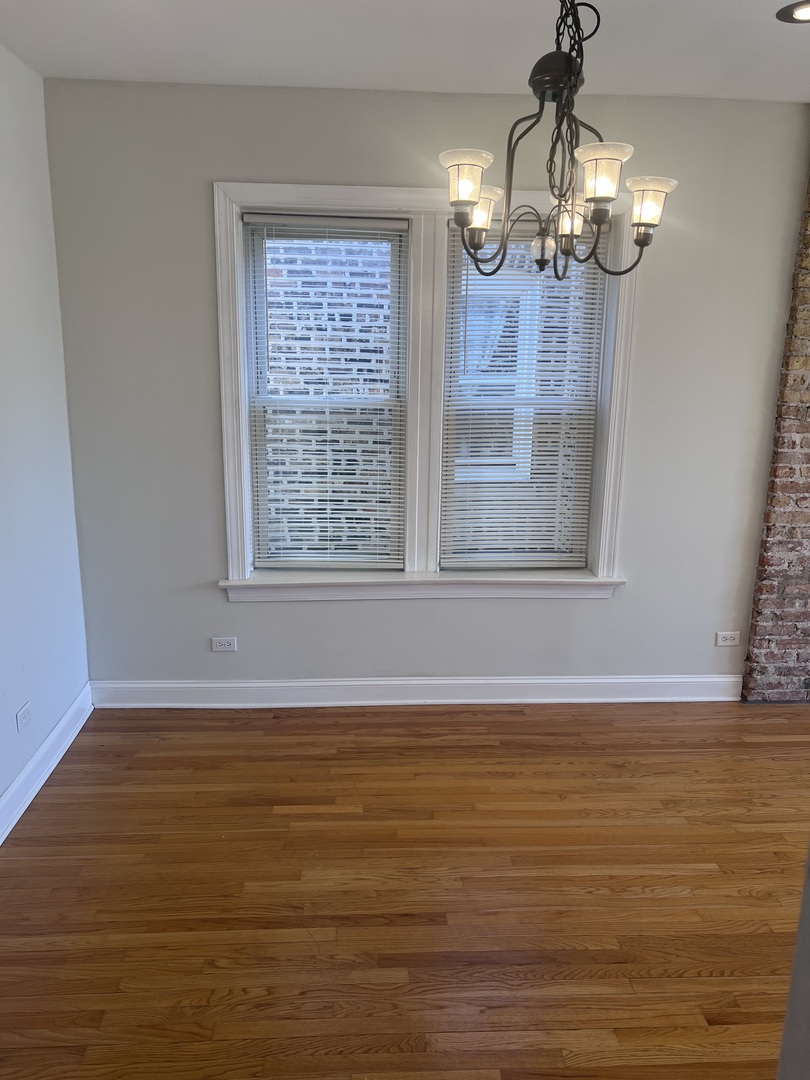 Undisclosed Address Chicago, IL 60622 - Photo 5 of 16 a view of an empty room with wooden floor and a window