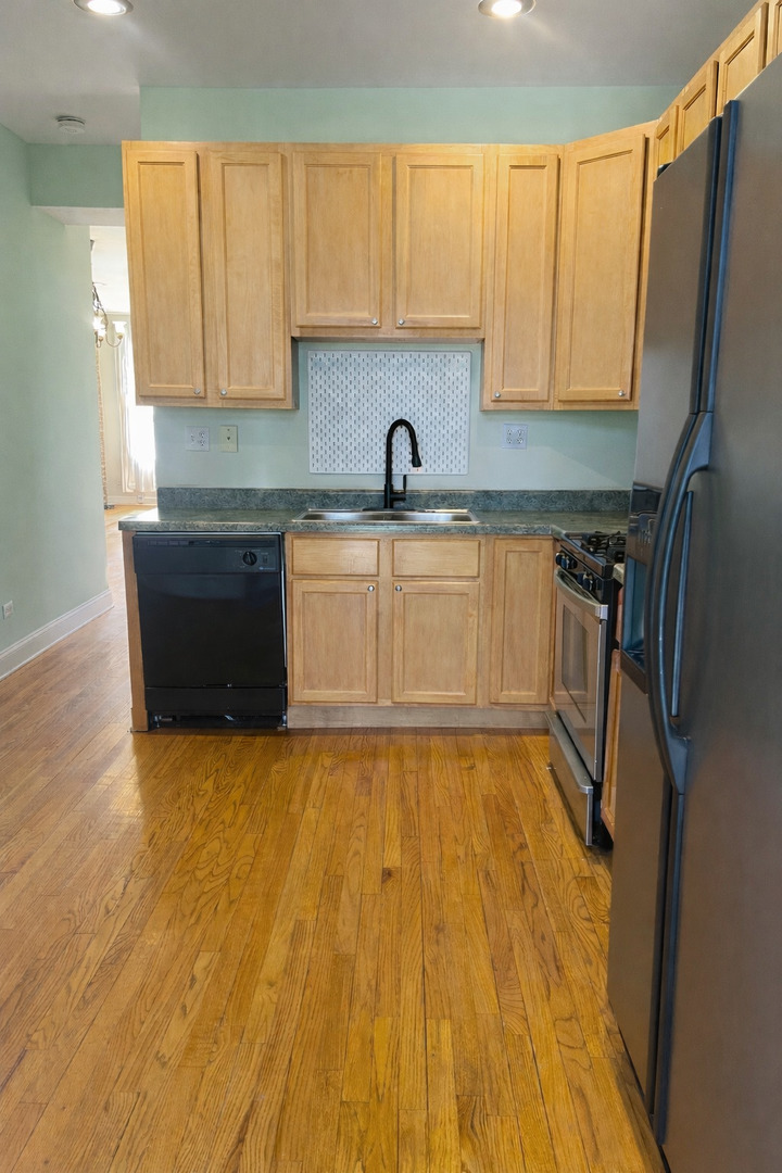 Undisclosed Address Chicago, IL 60622 - Photo 8 of 16 a view of a kitchen with a sink dishwasher and wooden floor
