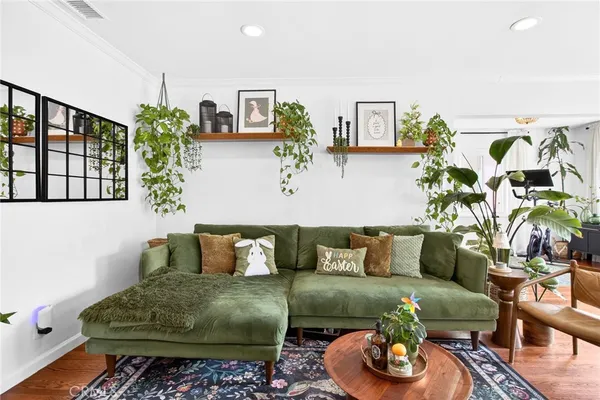 a living room with furniture a chandelier and a large window