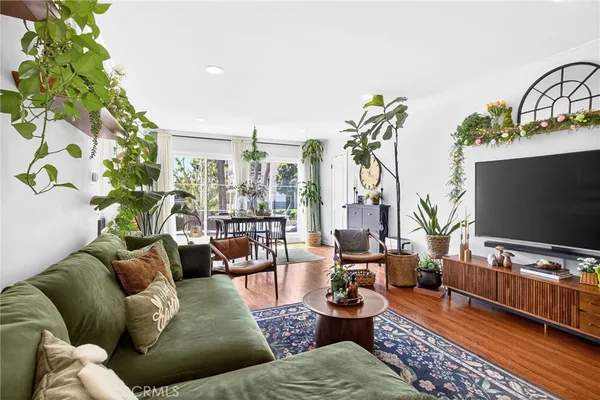 a living room with furniture and a potted plant
