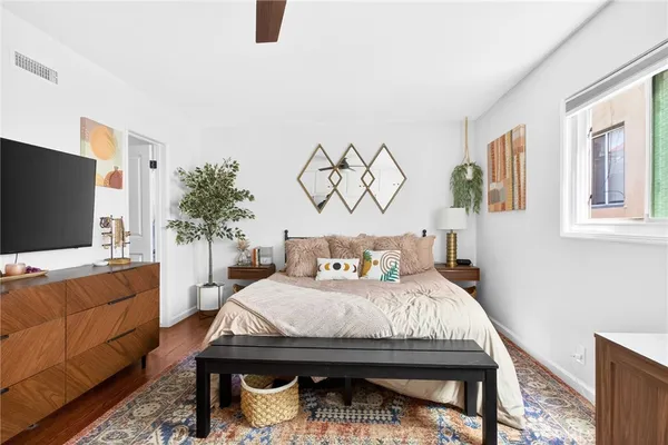 a bedroom with a bed and a flat screen tv