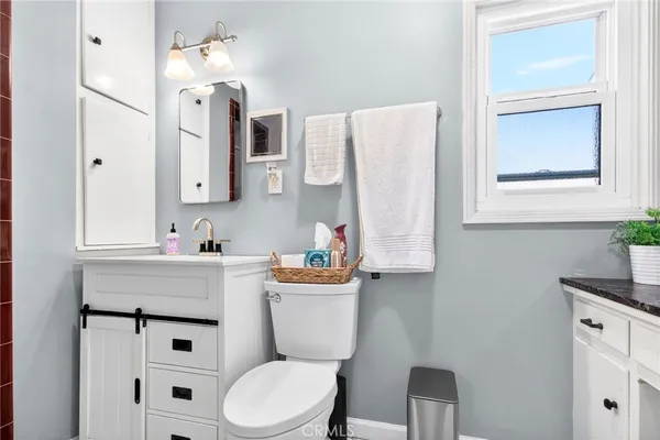 a white toilet sitting next to a shower curtain