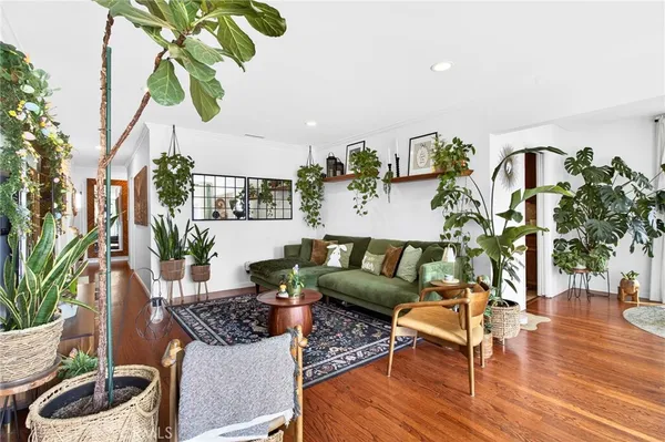 a table with chairs and a vase of flowers
