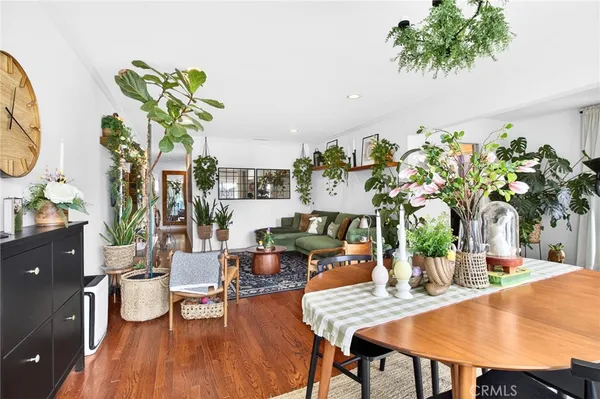 a kitchen with stainless steel appliances granite countertop a refrigerator a stove and a sink with wooden floor