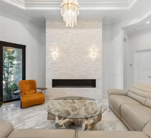a view of a dining room with furniture and chandelier