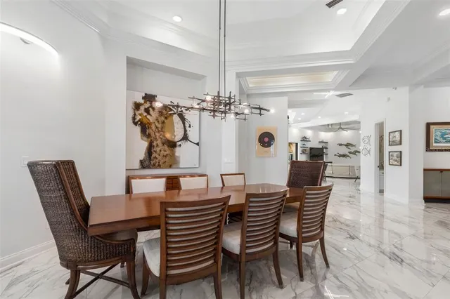 a dining room with furniture and large windows