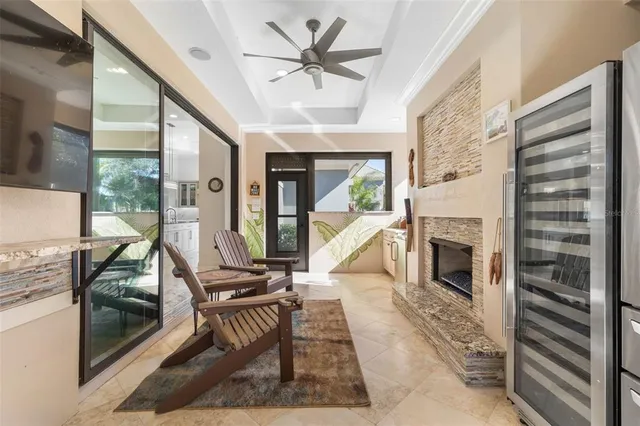 a view of a patio with couches and table and chairs under an umbrella