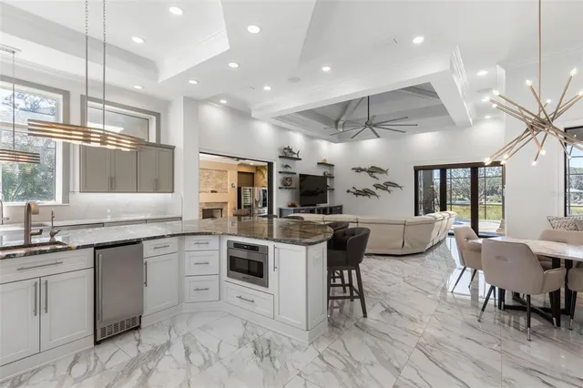 a kitchen with stainless steel appliances kitchen island granite countertop a sink and cabinets
