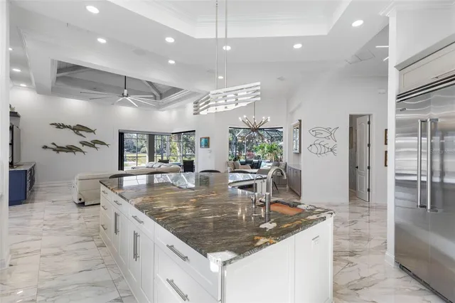 a dining room with stainless steel appliances kitchen island granite countertop a table and chairs