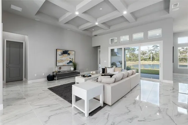 a large living room with stainless steel appliances kitchen island granite countertop a large counter top couches and couches with wooden floor