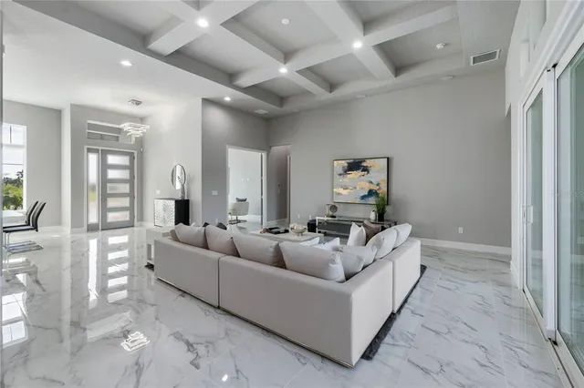 a kitchen with stainless steel appliances kitchen island granite countertop a table and chairs in it