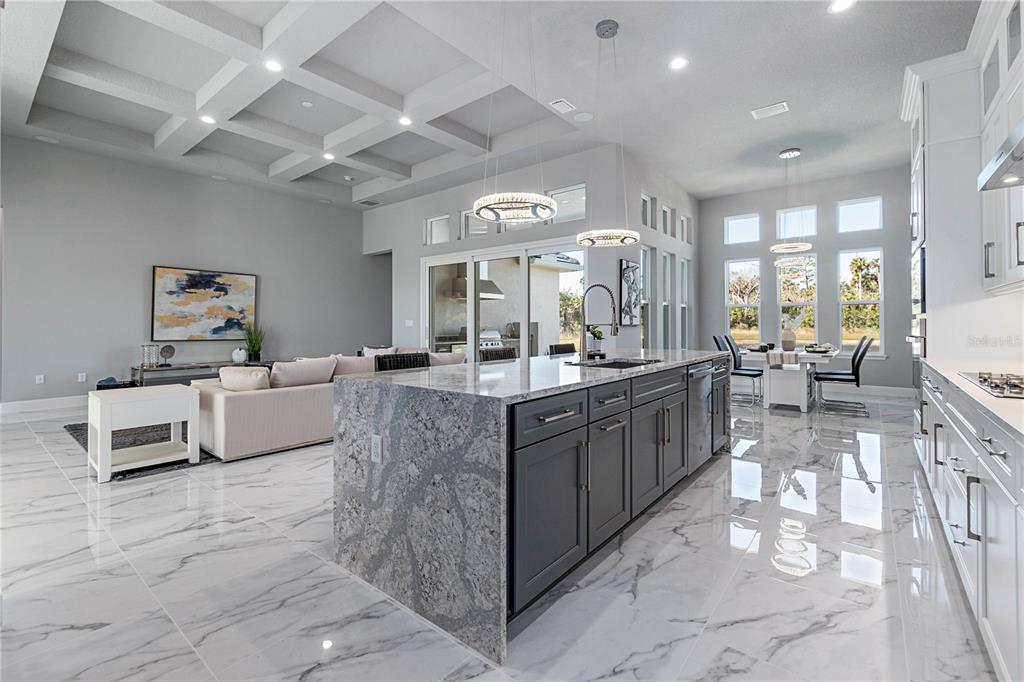 29 Coronado Road Flagler Beach, FL 32136 - Photo 15 of 81 a large living room with stainless steel appliances kitchen island granite countertop a large counter top couches and couches with wooden floor