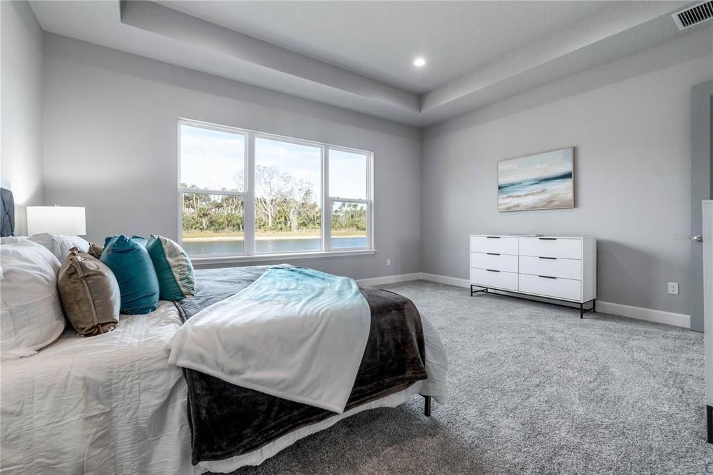 29 Coronado Road Flagler Beach, FL 32136 - Photo 25 of 81 a bedroom with a bed and a large window