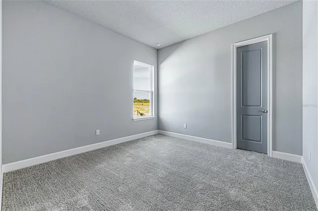 a view of a lake with a beach and a yard